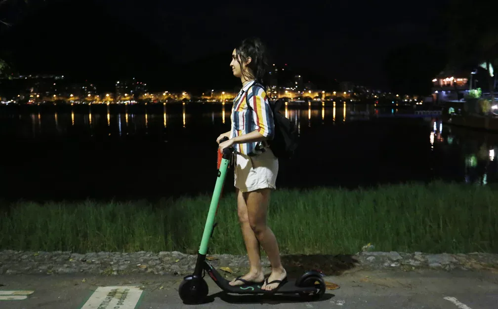 Person on an electric scooter at night, a common setting for falls and fractures